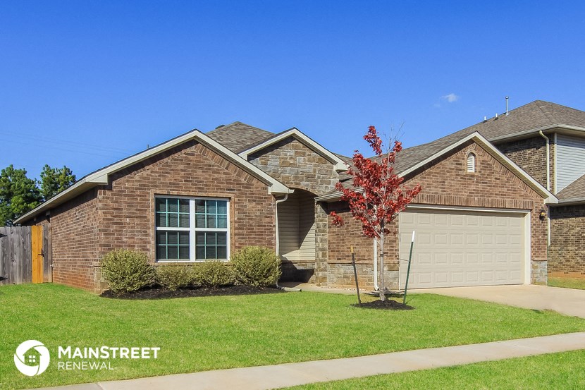 a house with a lawn and a tree in front of it