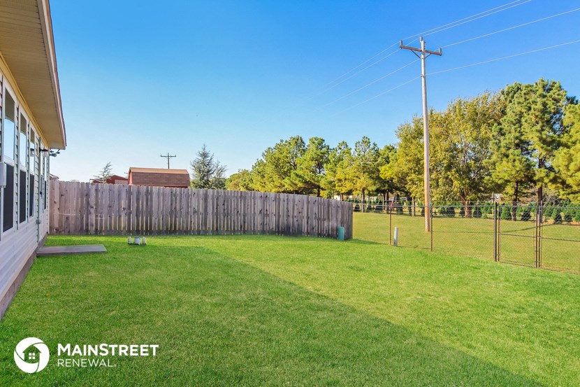 a backyard with a fenced in yard and a chain link fence