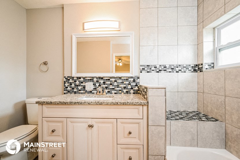 a bathroom with a sink and a mirror and a toilet
