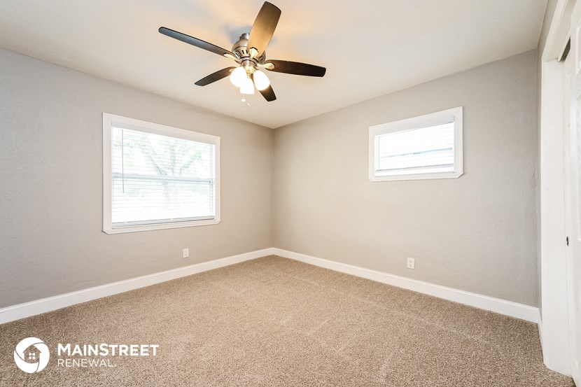 the master bedroom is spacious and has a ceiling fan