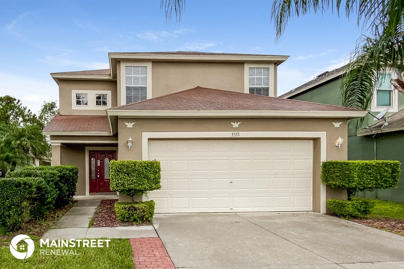 a beige house with a white garage door