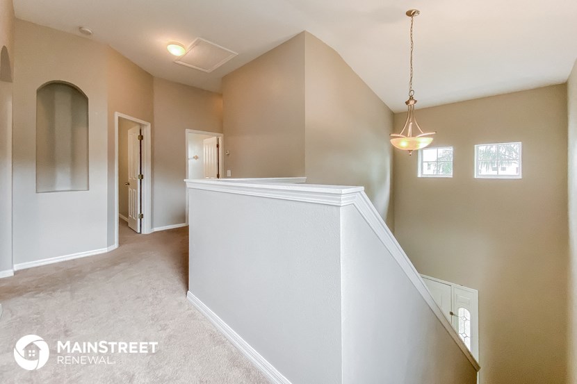 the upstairs laundry room is conveniently located next to the stairs