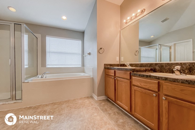 a bathroom with a sink and a shower and a bath tub