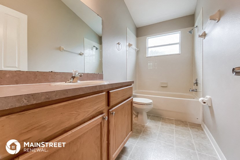 a bathroom with a sink and a toilet and a shower