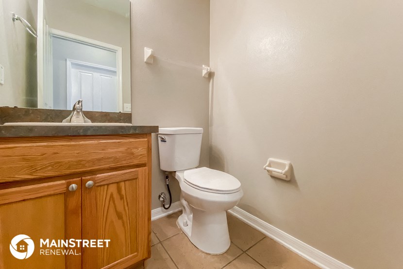 a bathroom with a toilet and a sink and a mirror