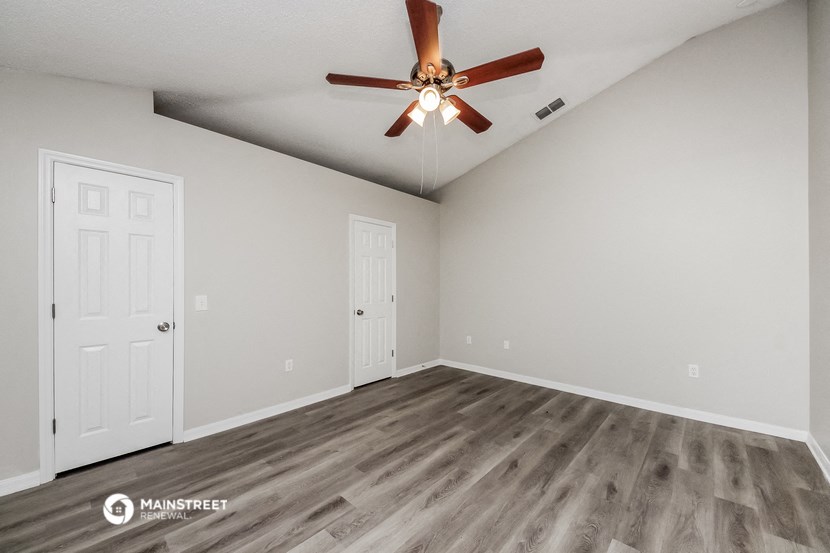 the spacious living room of our studio apartments atrium with ceiling fan