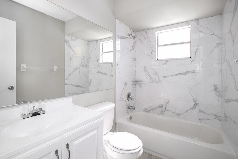 a bathroom with a sink toilet and a bath tub