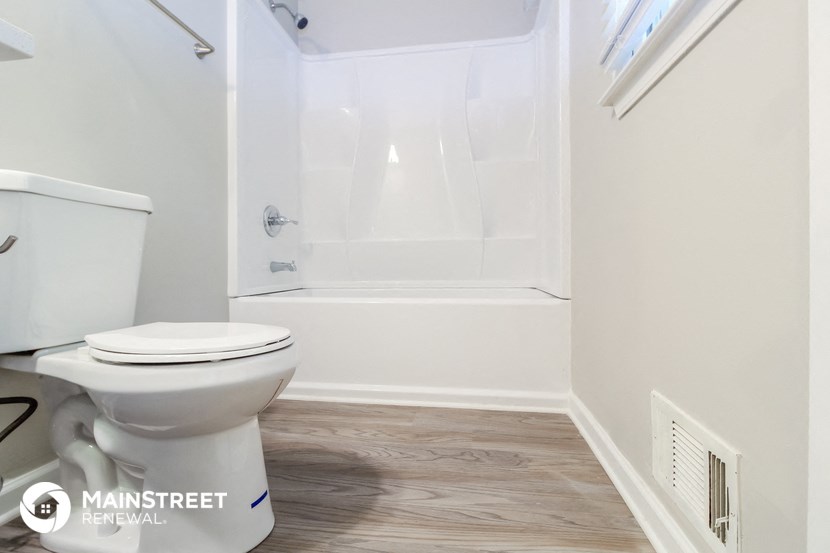 a small bathroom with a toilet and a shower