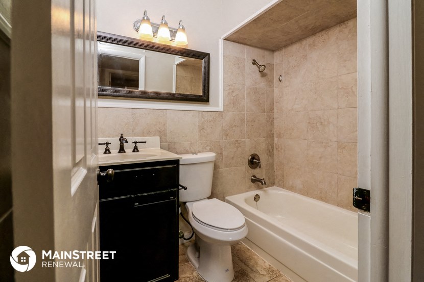 a bathroom with a sink toilet and a bath tub