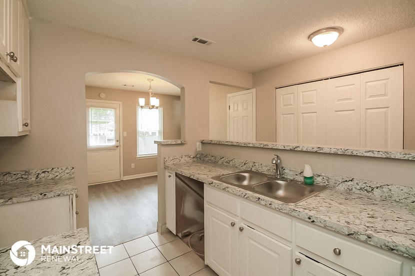 a kitchen with granite counter tops and a sink