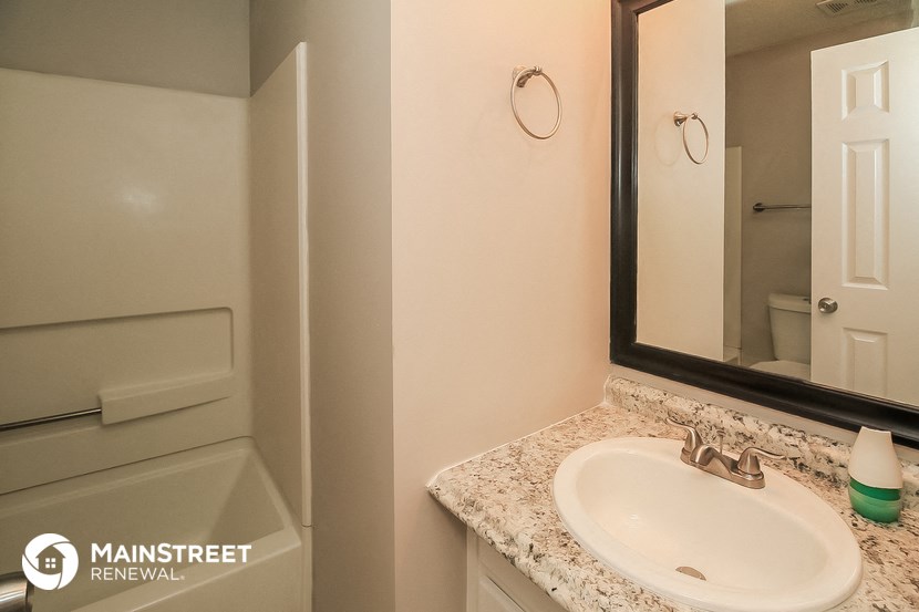 a bathroom with a sink and a mirror and a shower