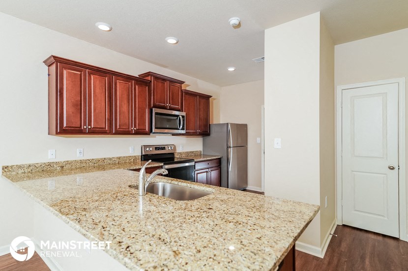 a kitchen with a granite counter top and a sink