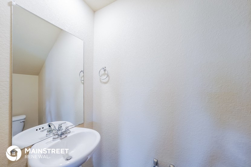 a white bathroom with a sink and a mirror