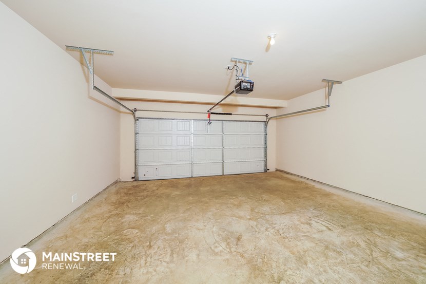 a garage with a white wall and a white garage door