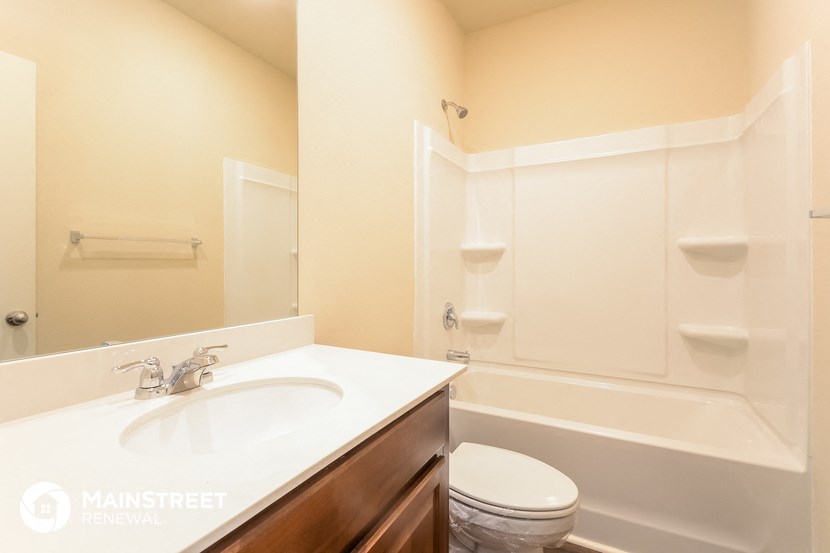 a bathroom with a sink and a toilet and a tub