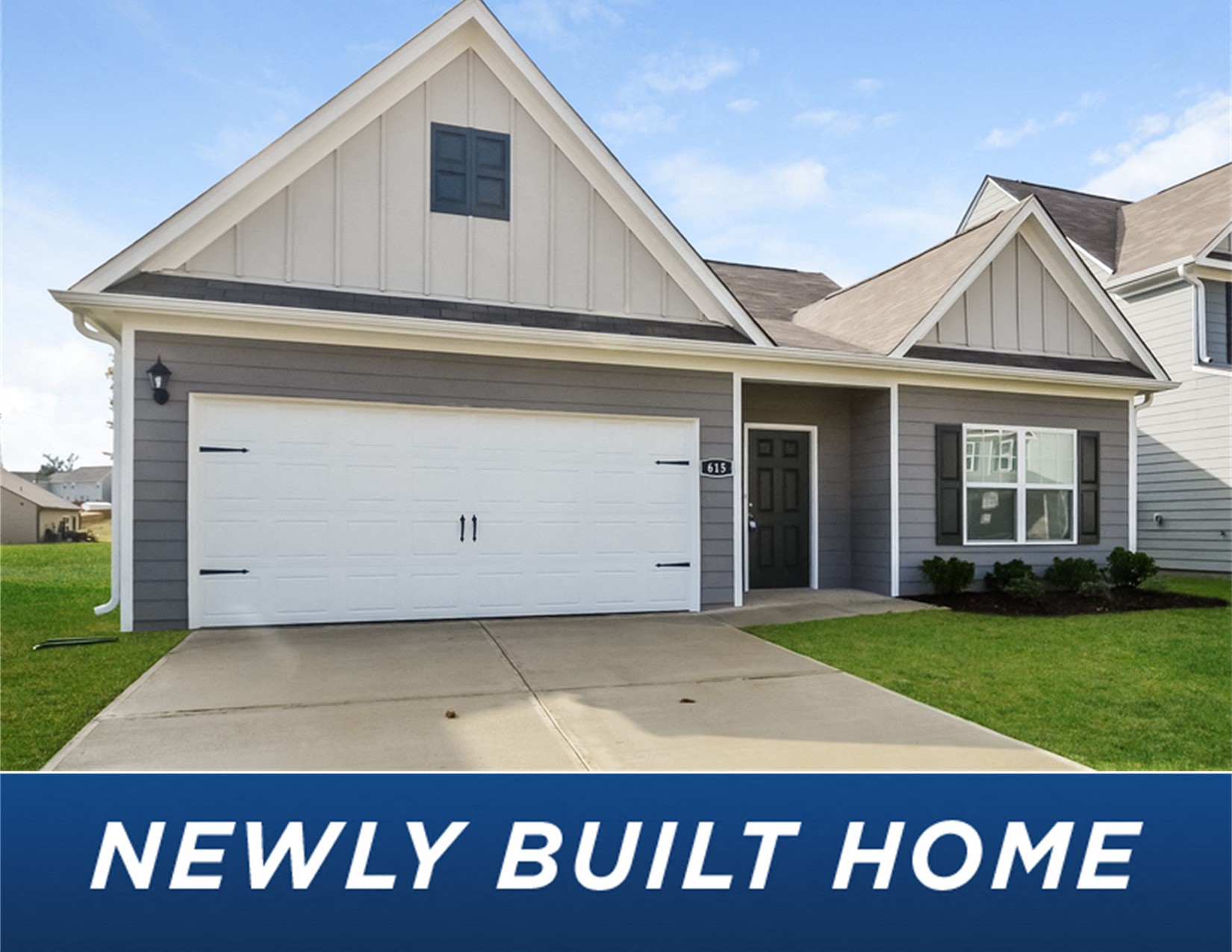 a new build home with a lawn and a driveway