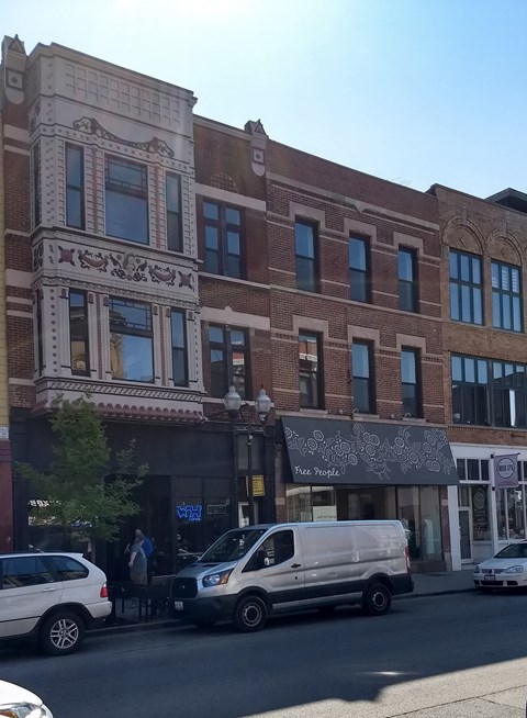 a van parked in front of a building on a city street