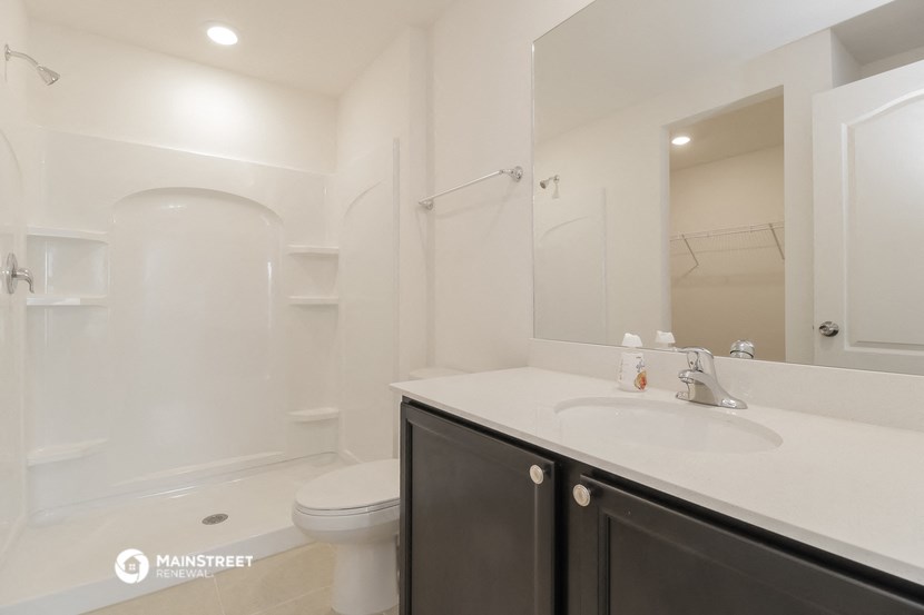 a white bathroom with a sink and a toilet