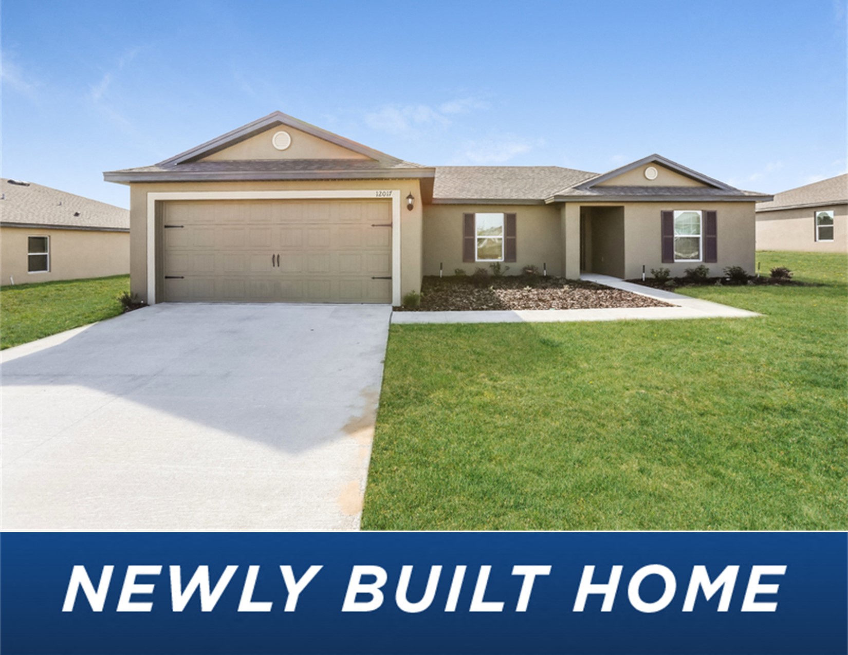 a new build home with a driveway and lawn