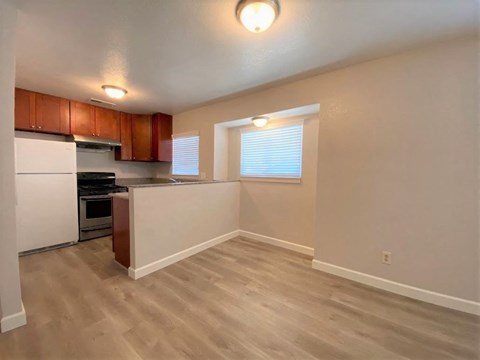 A kitchen with wooden cabinets and a white refrigerator.
