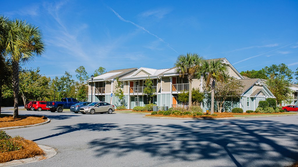 an apartment building with cars parked in front of it