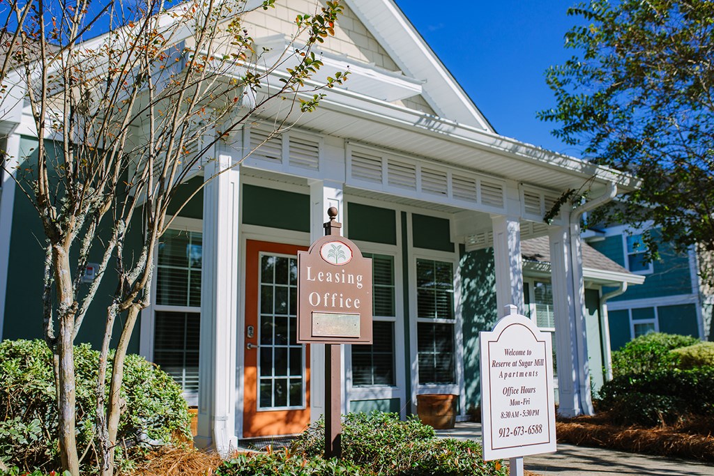the leasing office is shown in front of a white building