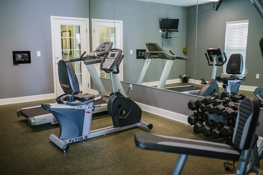 a gym with treadmills and other exercise equipment