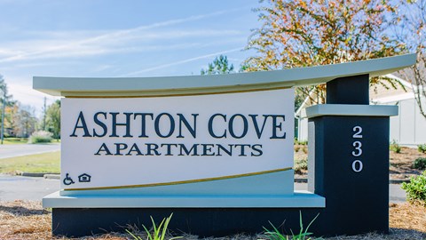 a sign apartments on the side of a road