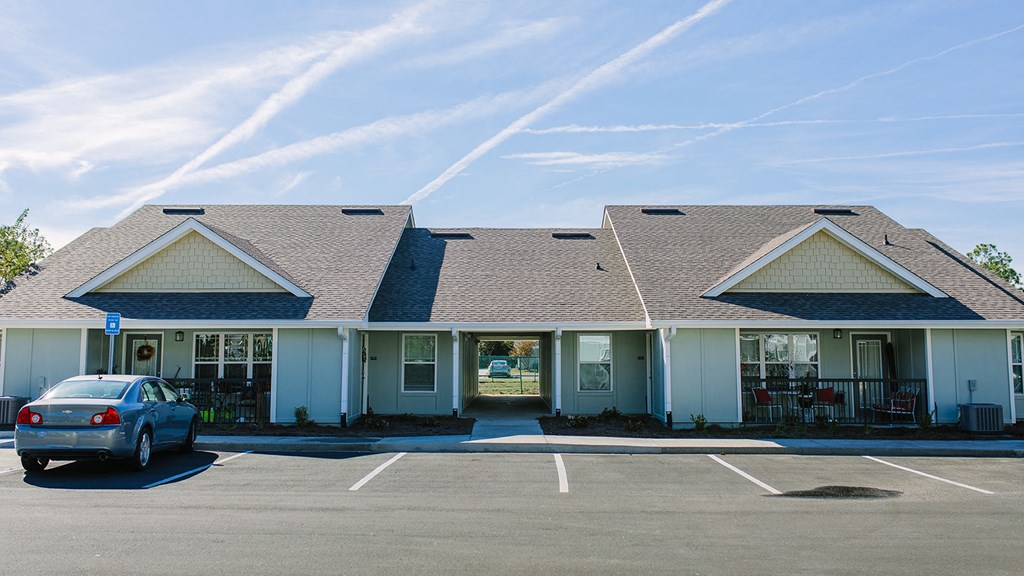 a building with a car parked in a parking lot
