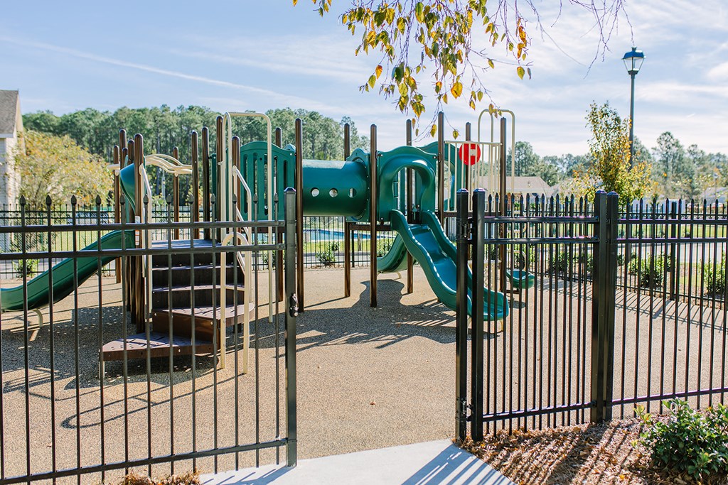 a playground with slides and climbing equipment in a park