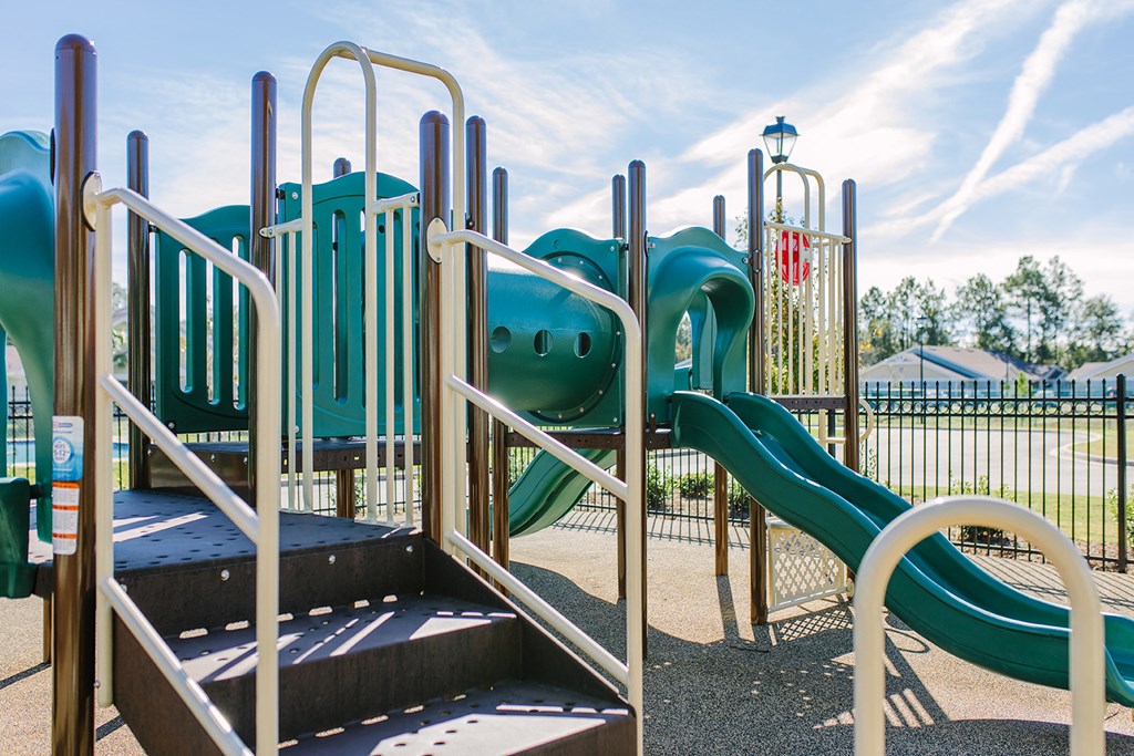 a playground with slides and climbing equipment at a park