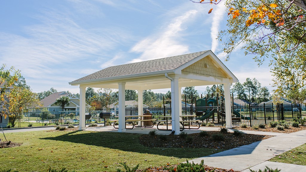 a pavilion with a picnic table in a park