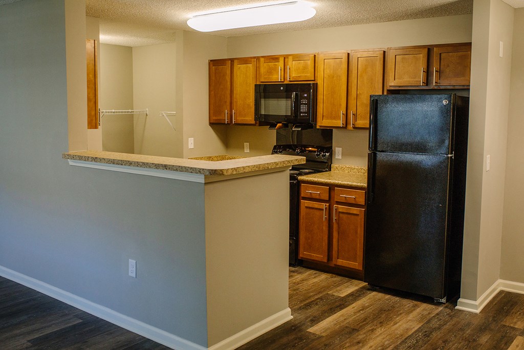 a kitchen with a counter top and a refrigerator