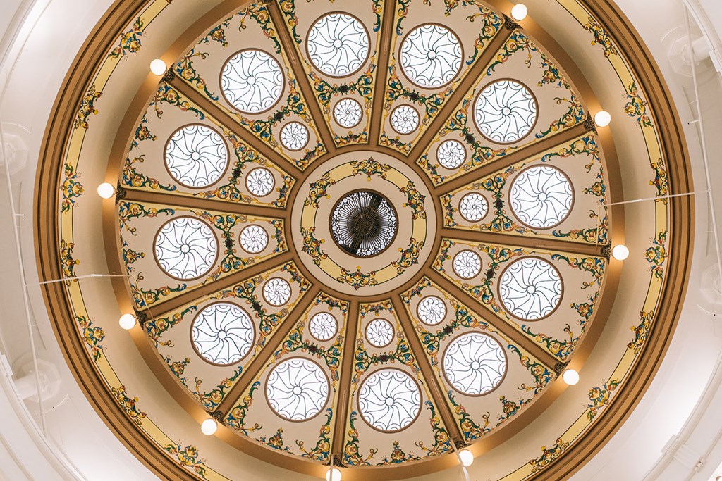 the ornately decorated ceiling of the dome of the building