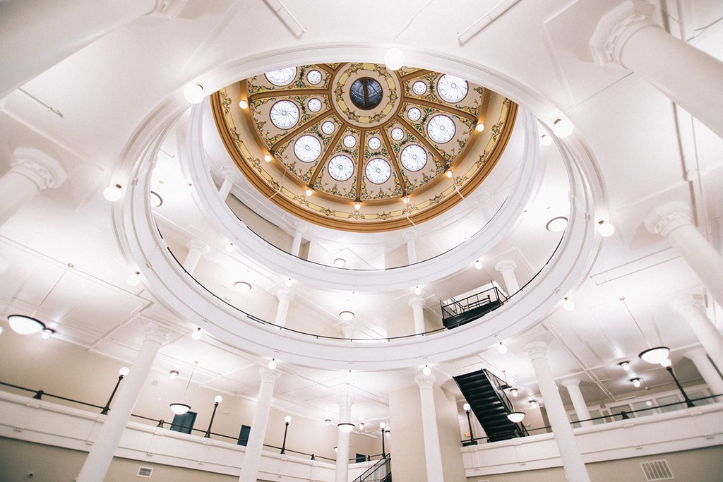 a view of the ceiling of a church with a stained glass dome