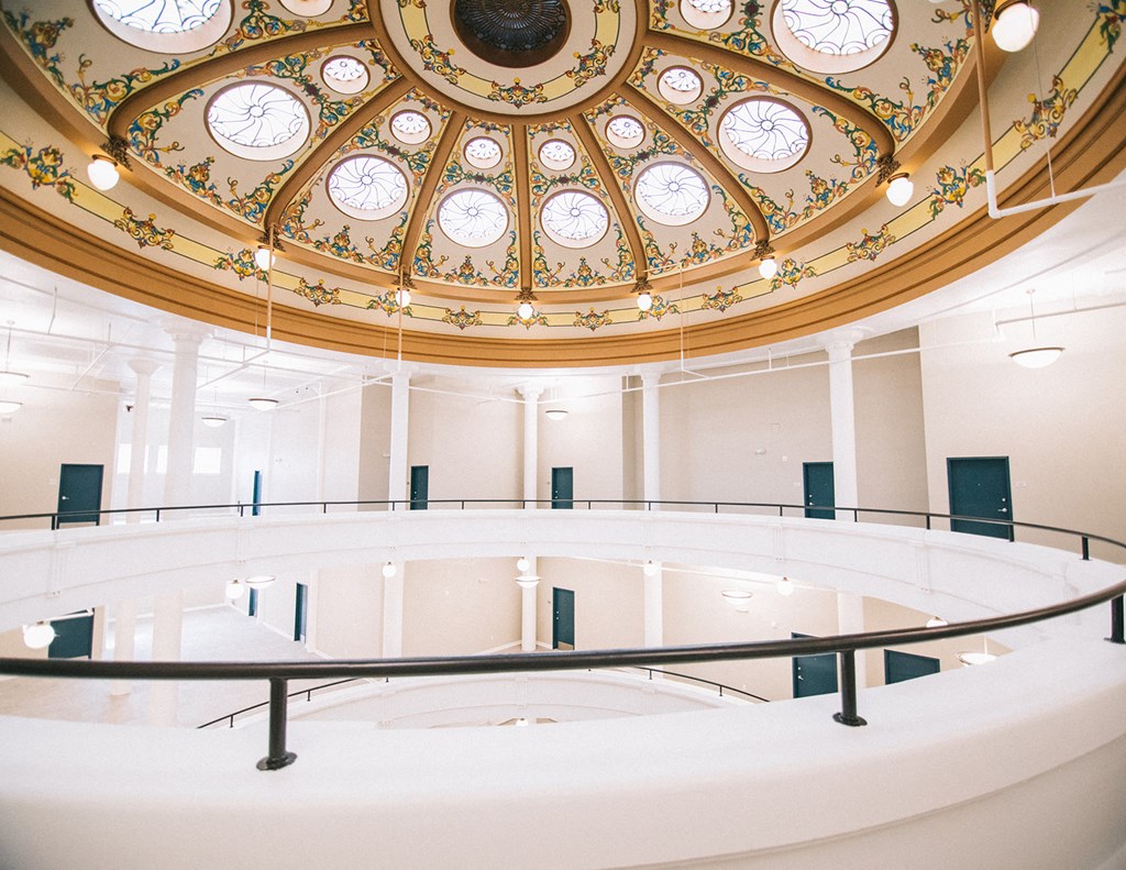 the inside of a large building with a large circular staircase