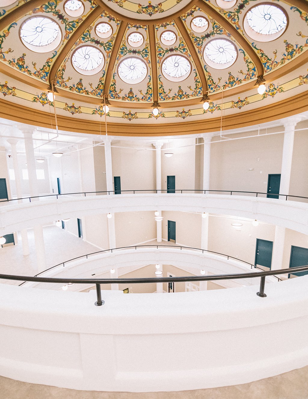 the inside of a large building with a large clock on the ceiling