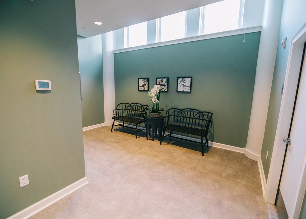 a dining room with a table and chairs and a green wall