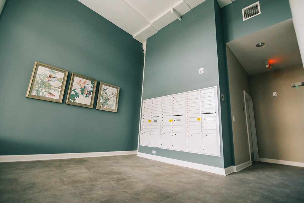 a room with lockers and paintings on the wall and a door