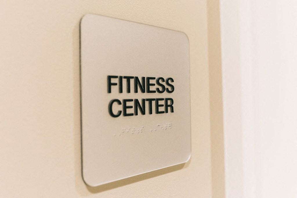 a sign for a fitness center on a wall
