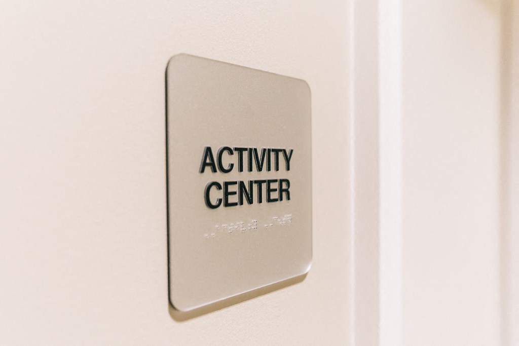 an activity center sign on a wall next to a door