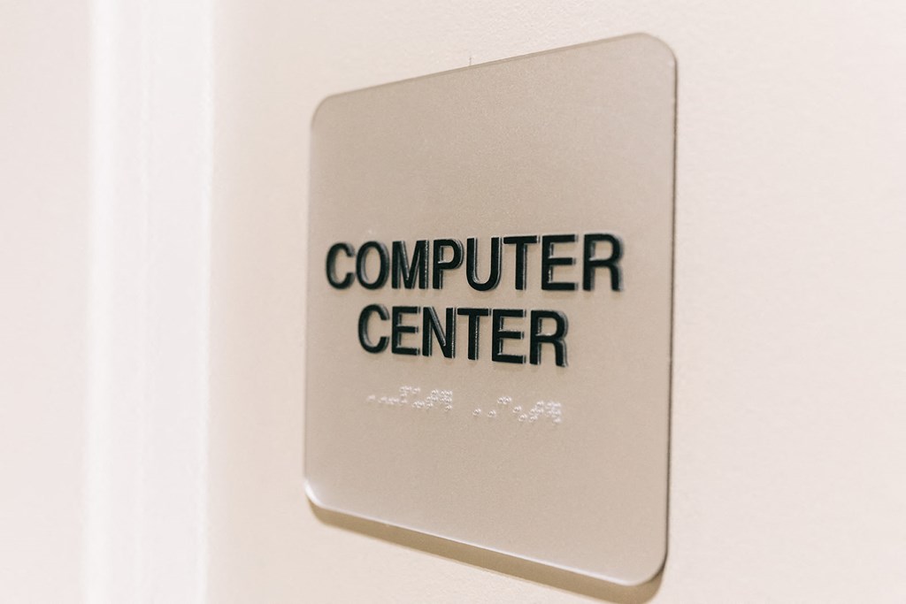 a computer center sign on a white wall