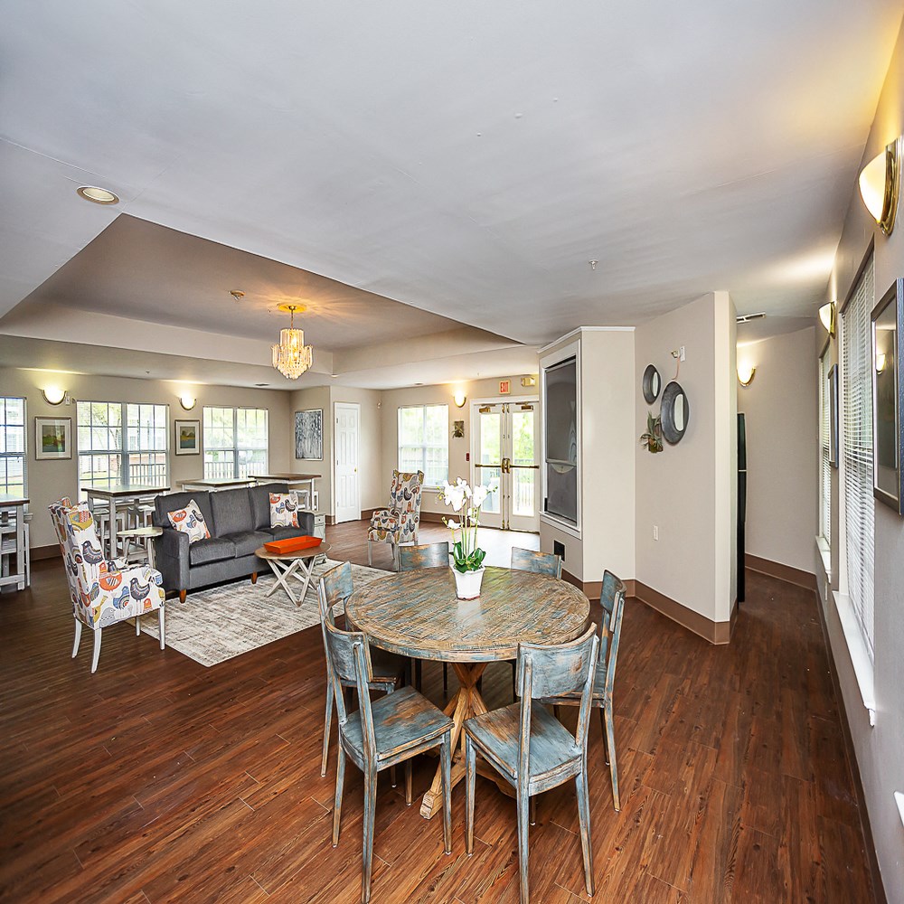 a living room with a dining room table and a couch