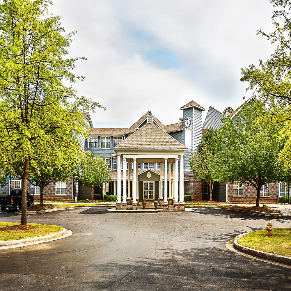 a view of the front entrance of a building with trees