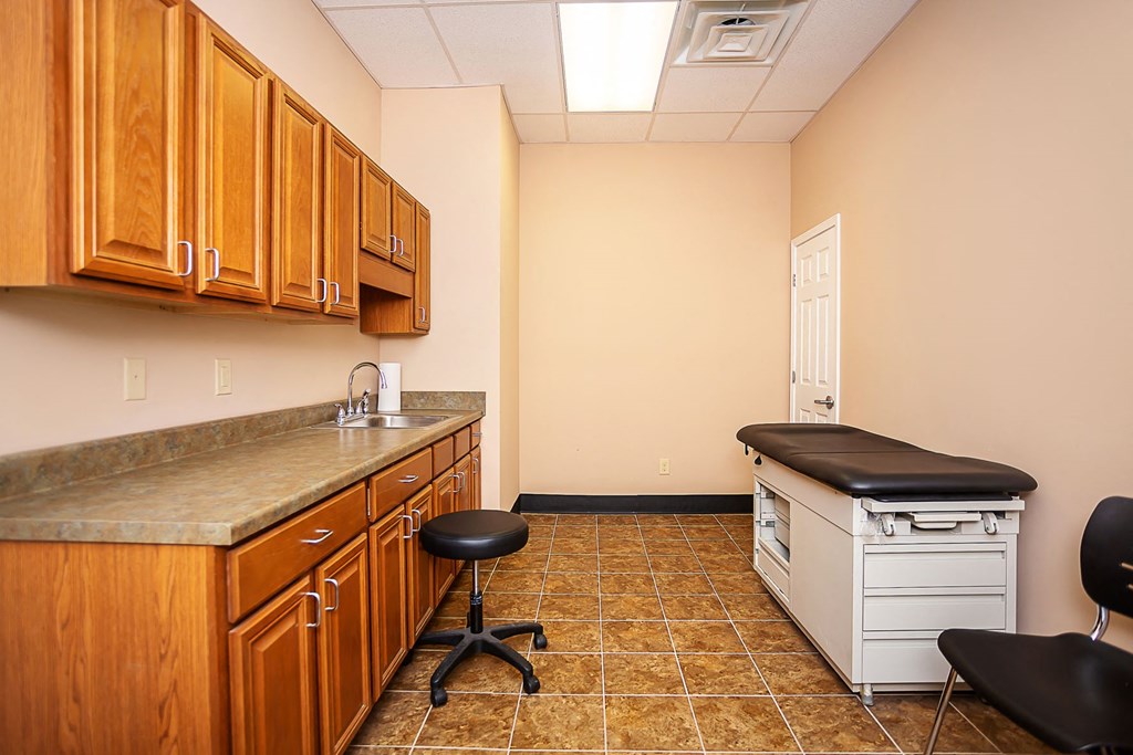 a small office room with a desk and a chair
