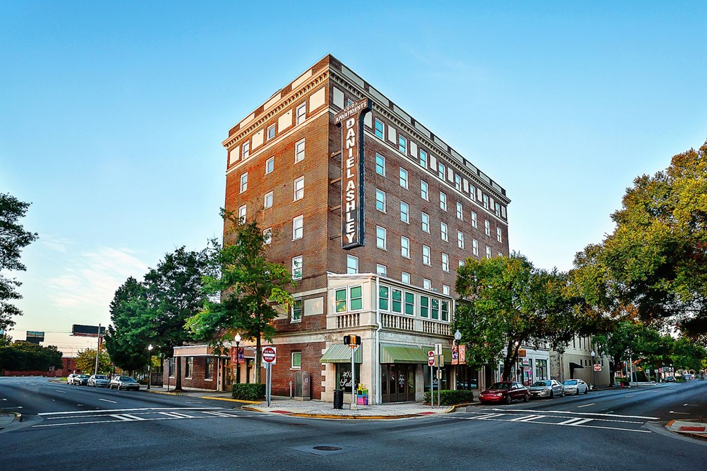 a tall brick building on the corner of a city street
