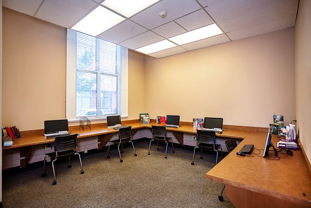 a large room with desks with computers and chairs