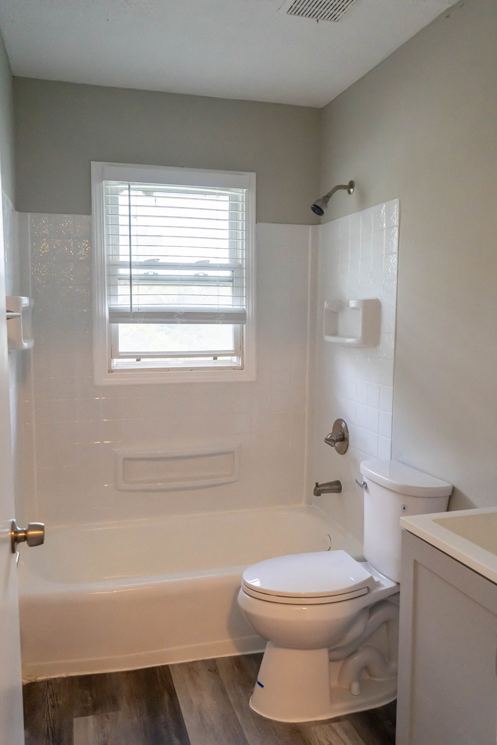 a small bathroom with a toilet and a bath tub