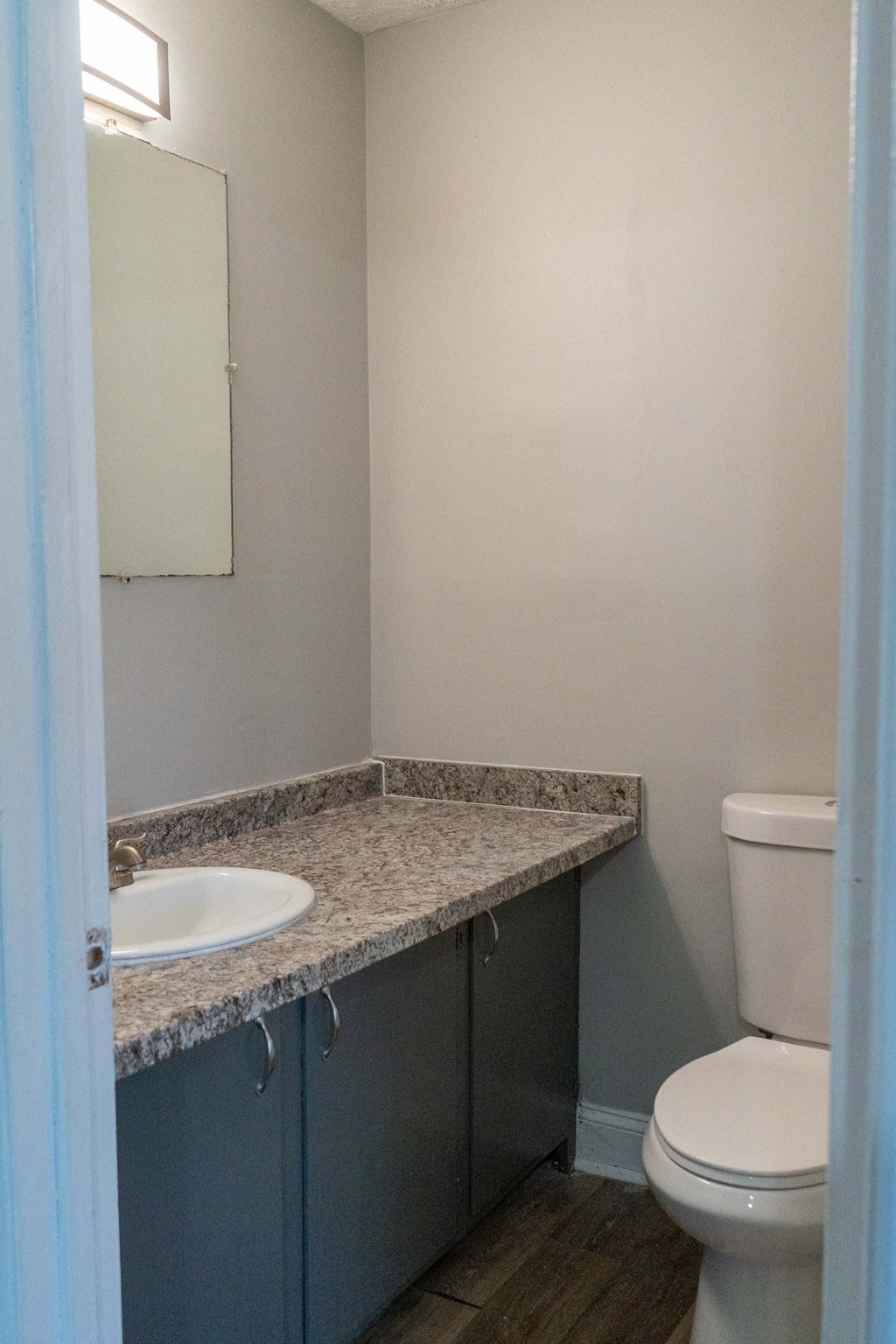 a bathroom with a sink toilet and a mirror