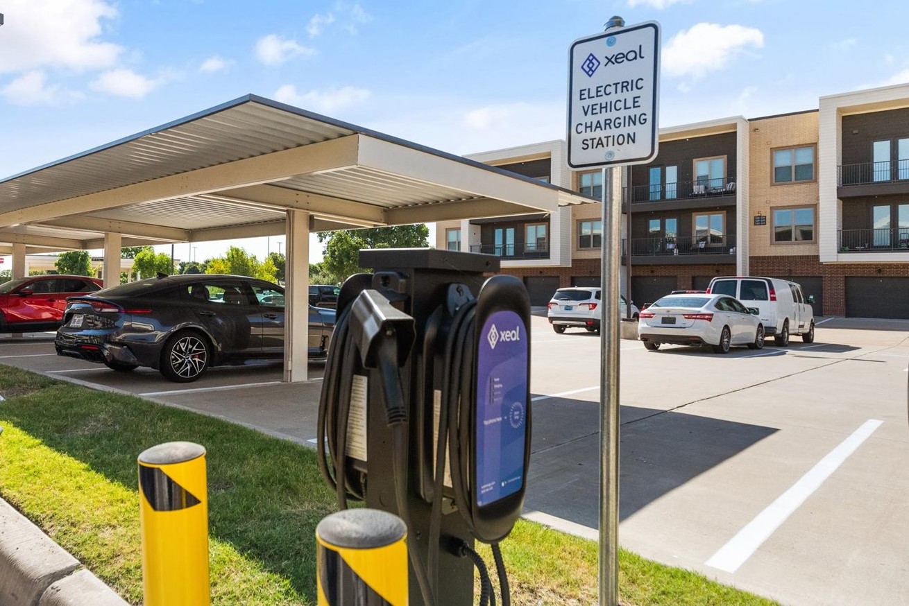 an electric vehicle charging station in a parking lot with cars parked